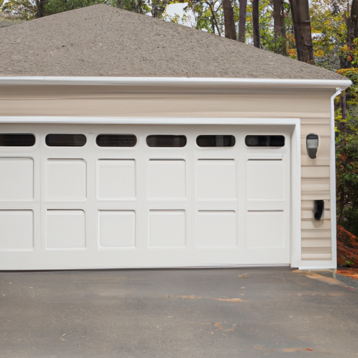 Paneled garage door on a suburban Milton, MA home showing door material and visible hardware in overcast light.